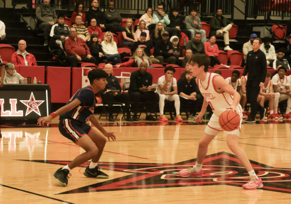 Coppell senior guard Bryce Ward sets up the Cowboys offense against Frisco Centennial on Tuesday at CHS Arena. The Coppell boys basketball team defeated Centennial, 75-59.